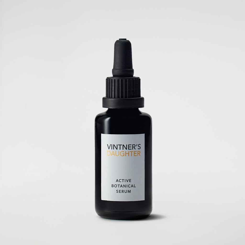 Vintner's Daughter Active Botanical Serum in a 30 milliliter black glass dropper bottle on a plain light gray background