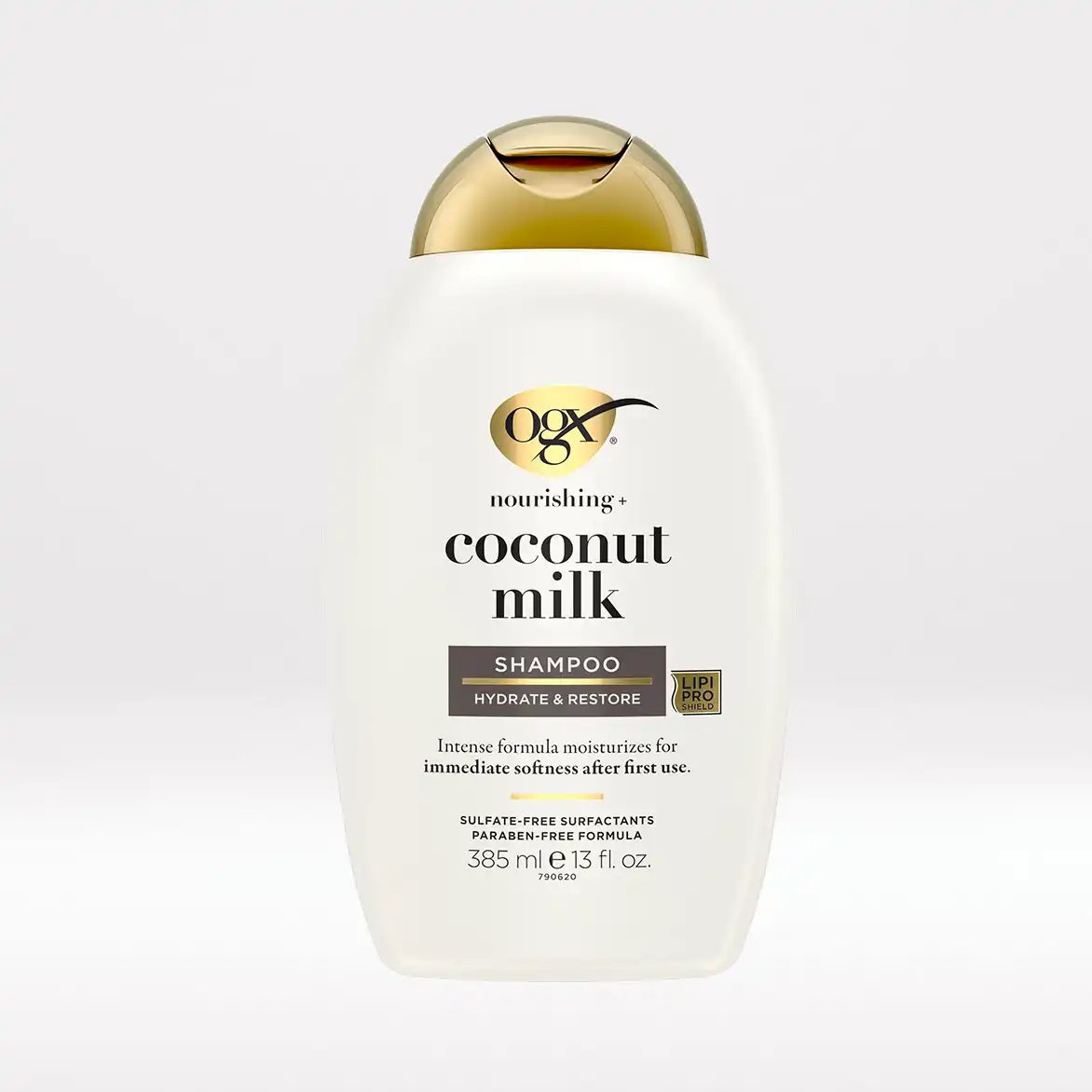 OGX Nourishing + Coconut Milk Shampoo 13 fl oz white bottle with a gold domed cap, front of pack reading sulfate free surfactants and paraben free formula.