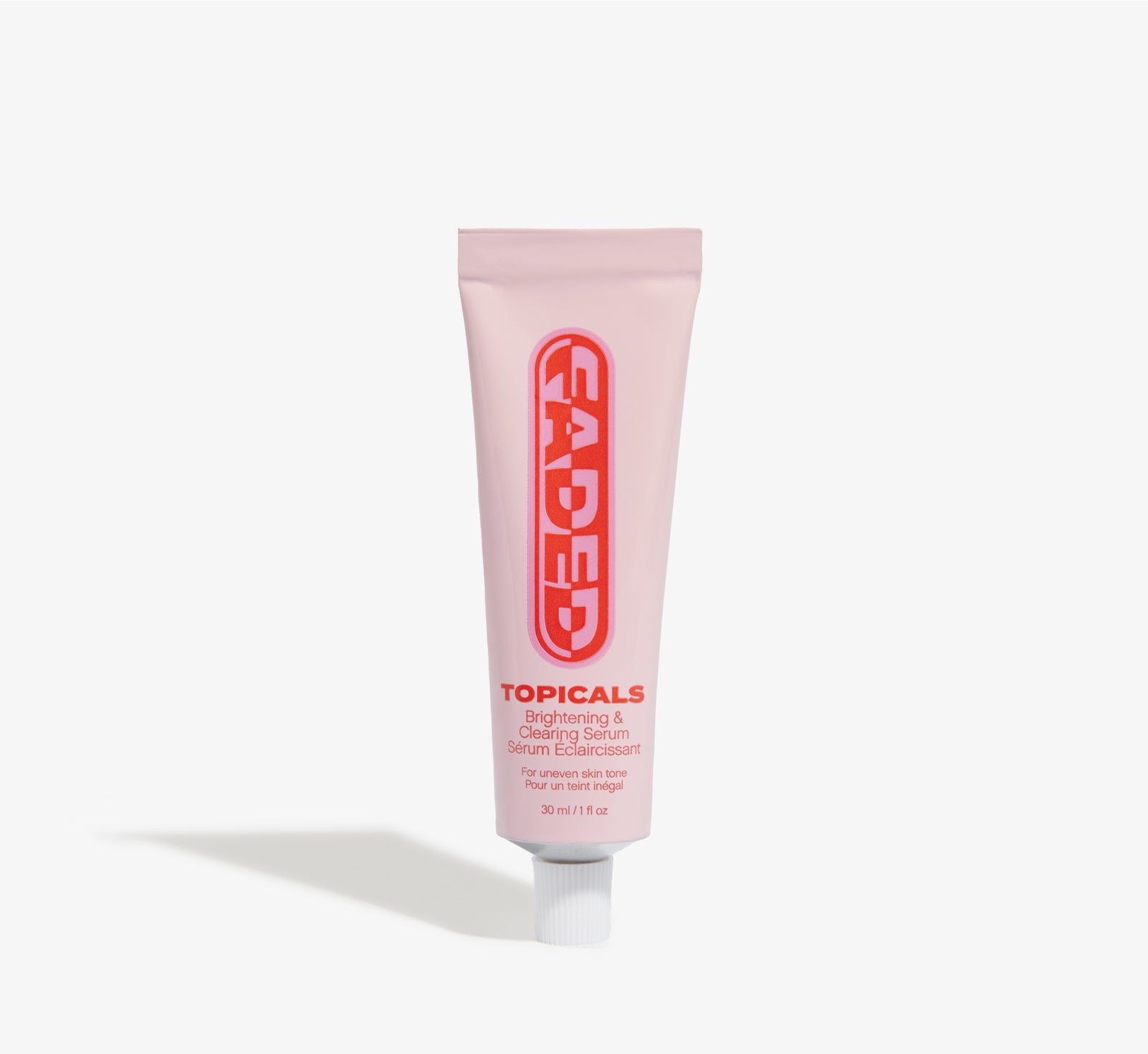 A pink Topicals Faded Brightening and Clearing Serum tube on a plain white background